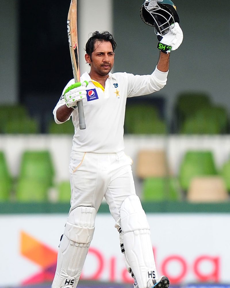 Pakistan cricketer Sarfraz Ahmed raises his bat and helmet in celebration after scoring a half-century (50 runs) during the second day of the second Test match between Sri Lanka and Pakistan at the Sinhalese Sports Club (SSC) Ground in Colombo on August 15, 2014. AFP PHOTO / LAKRUWAN WANNIARACHCHI        (Photo credit should read LAKRUWAN WANNIARACHCHI/AFP/Getty Images)